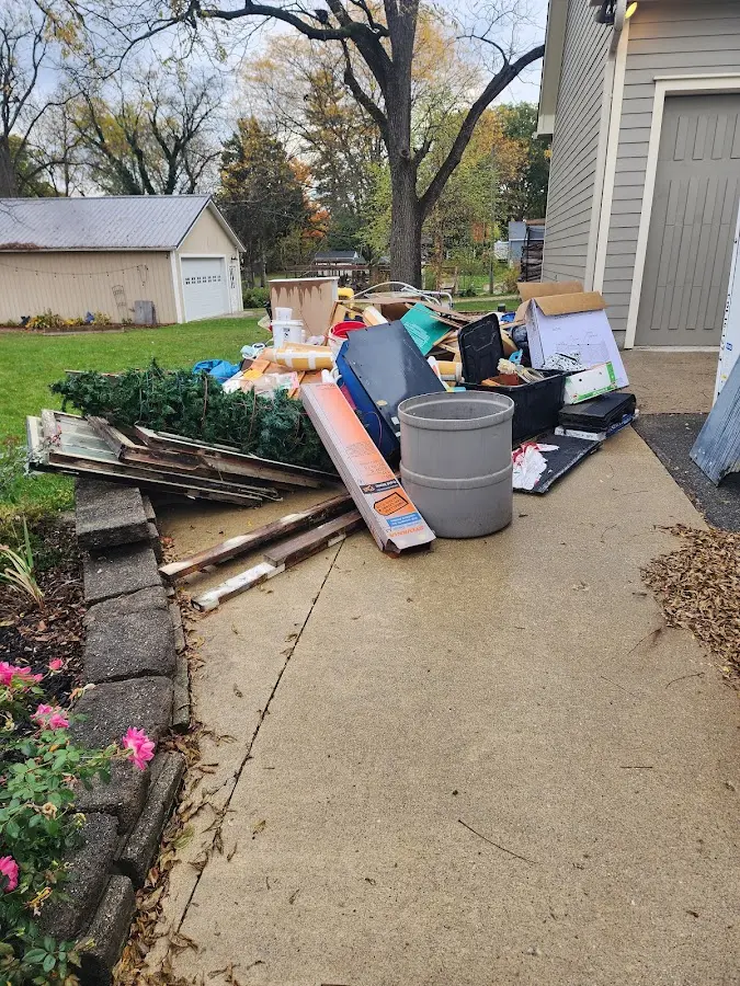 Dumpster being loaded with debris for Roofing Dumpster Rental in Orange City